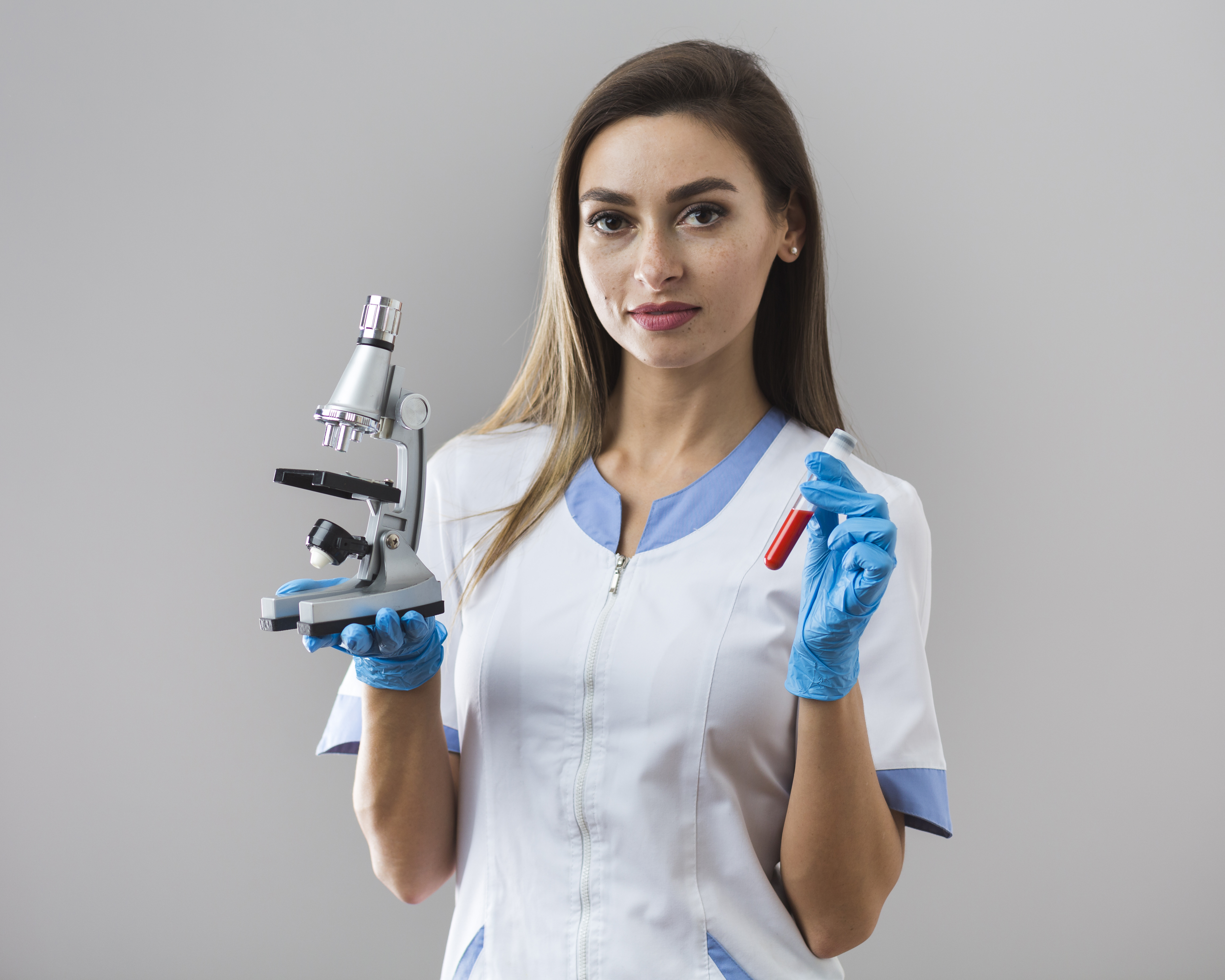 woman-holding-blood-sample-microscope
